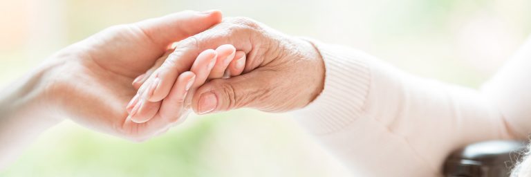 Close-up of tender gesture between two generations